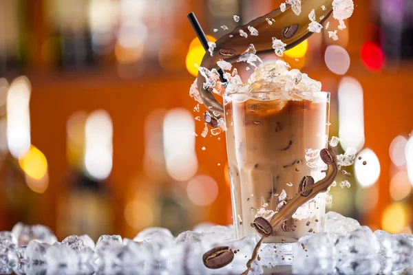 Bevanda di caffè freddo con ghiaccio, fagioli e spruzzi — Foto Stock