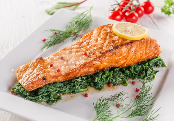 Delicious salmon steak on white plate — Stock Photo, Image