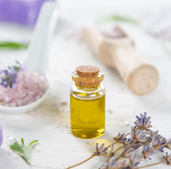 Wellness treatments with lavender flowers on wooden table. — Stock Photo, Image
