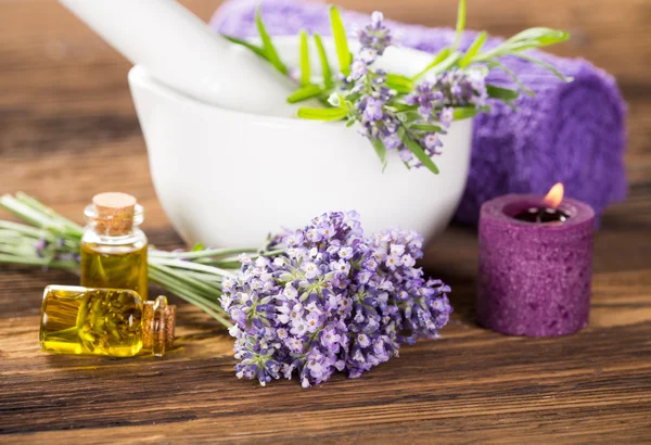 Wellness treatments with lavender flowers on wooden table. — Stock Photo, Image