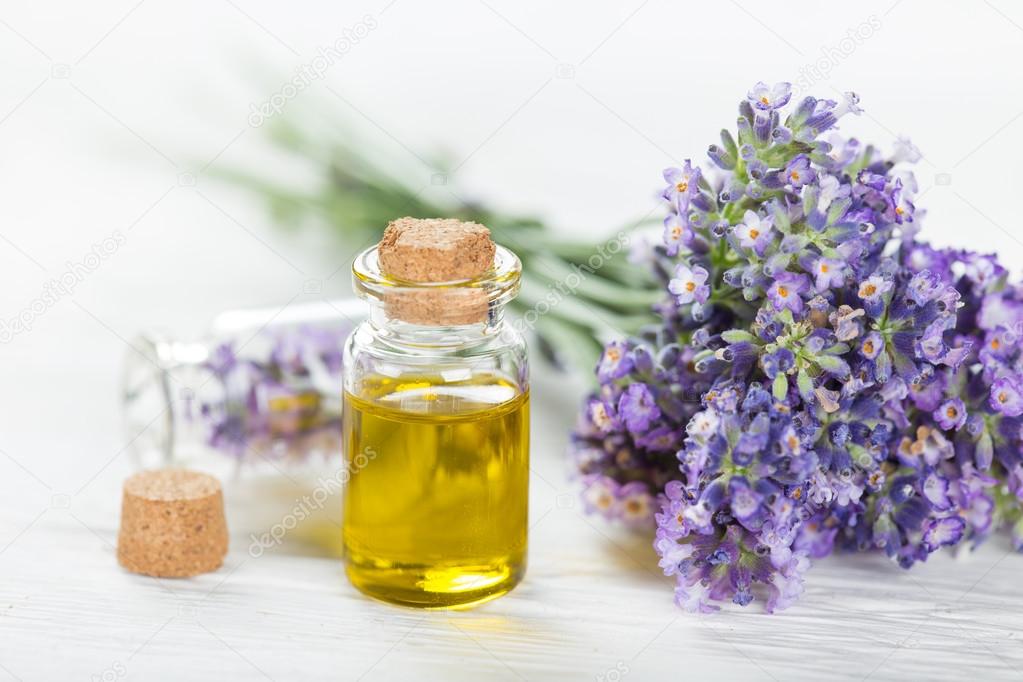 Wellness treatments with lavender flowers on wooden table.