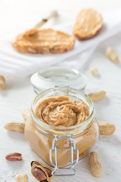 Peanut butter on wooden background. — Stock Photo, Image