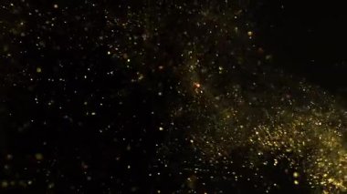 Siyah zemin üzerinde izole edilmiş küçük altın parçacıklar uçuşuyor. Yüksek hızlı kamera, 1000 fps.