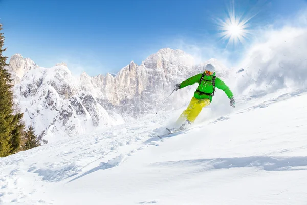 Skier skiing downhill in high mountains — Stock Photo, Image