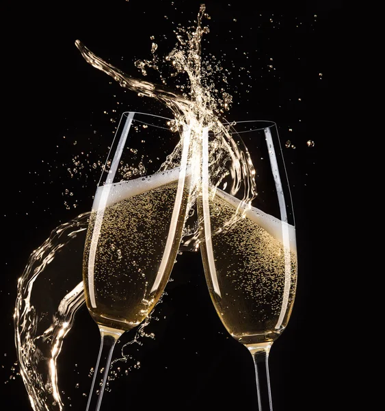 Glasses of champagne with splash, celebration theme. — Stock Photo, Image