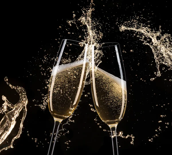 Glasses of champagne with splash, celebration theme. — Stock Photo, Image