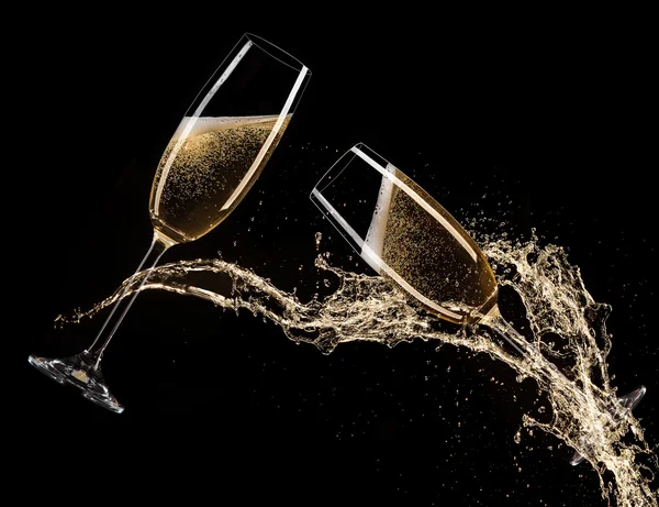 Glasses of champagne with splash, celebration theme. — Stock Photo, Image