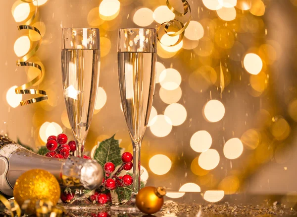 Glasses of champagne with bright gold background