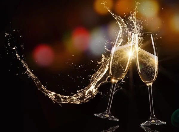 Glasses of champagne with splash — Stock Photo, Image