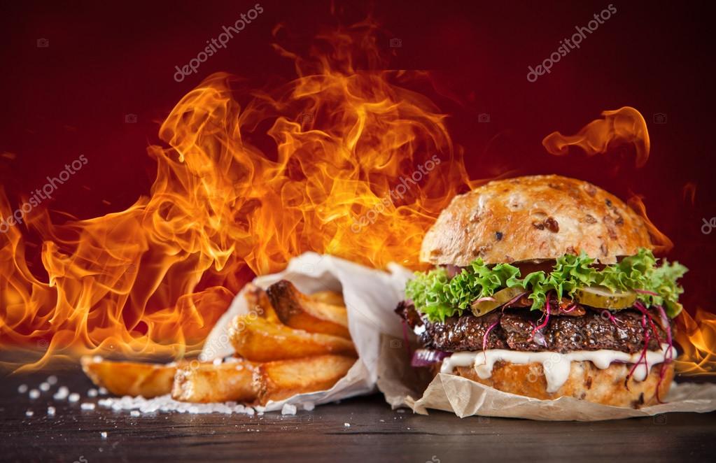Home made burgers with fire flames. — Stock Photo © Kesu01 97199864