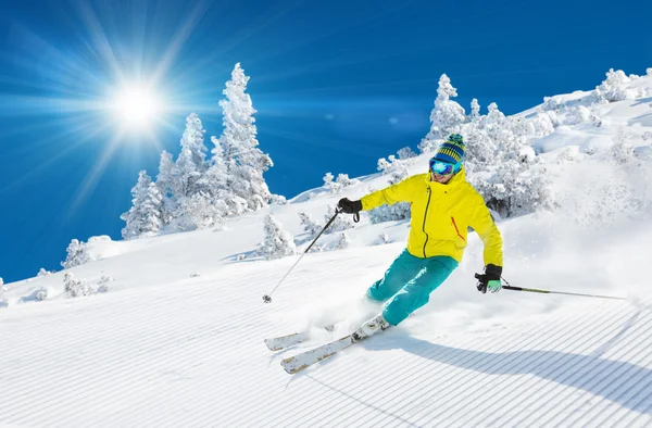 Skier skiing downhill in high mountains — Stock Photo, Image