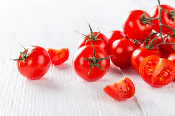 Tomates cherry frescos sobre una mesa de madera —  Fotos de Stock