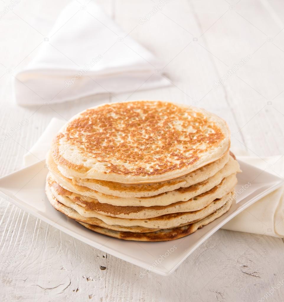 Stack of pancakes on white wooden table