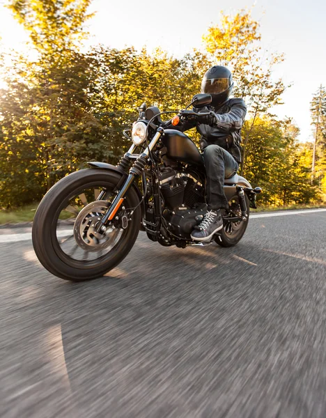 Männersitz auf dem Motorrad auf der Forststraße. — Stockfoto