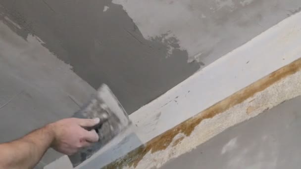 Рука з поплавцем вирівнює стелю штукатуркою — стокове відео