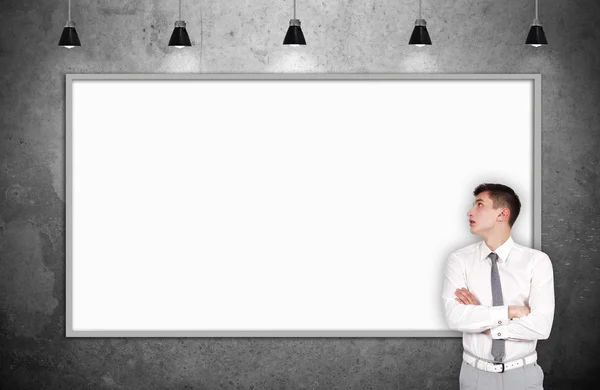 Businessman standing in gallery — Stock Photo, Image