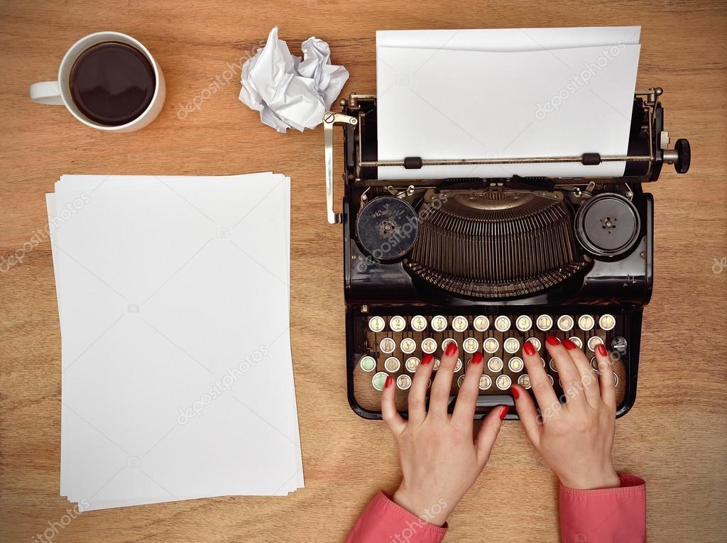 Hands typing on a Vintage typewriter.