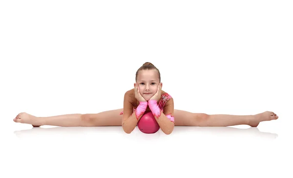 Gymnast sitting on split with ball — Stock Photo, Image