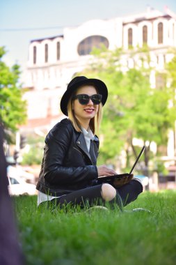 çimenlerin üzerinde oturan hippi kız