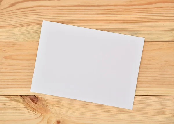 Paper on wooden table — Stock Photo, Image