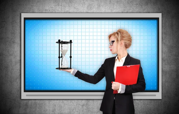 Businesswoman holding sandglass — Stock Photo, Image