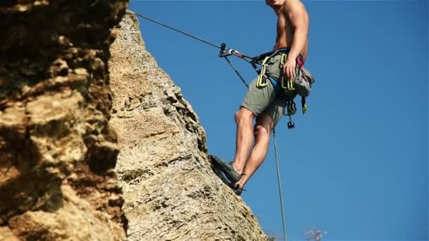 Arrampicante appeso alla roccia e si presenta Pollice. Effetto rallentamento — Video Stock