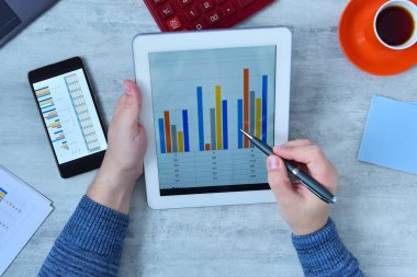 Office man doing business and charts being demonstrated on screen of a tablet. Success and startup concept.