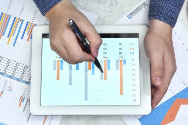 Businessman work with documents on digital tablet computer screen. Finance and trade concept. Close up