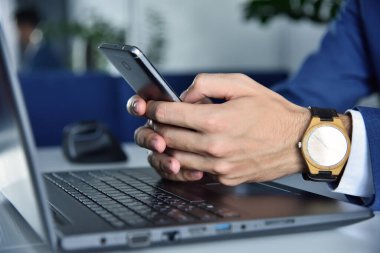 Finans analisti akıllı telefondan mesaj yazıyor. İş ve iş kavramı. Kapat.