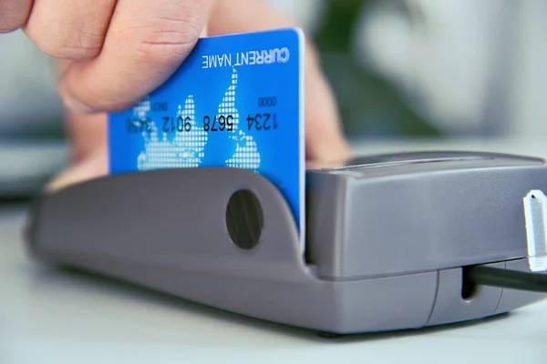 Close up of pay money credit card for spending money with payment pos terminal. Transaction pay and shopping concept.