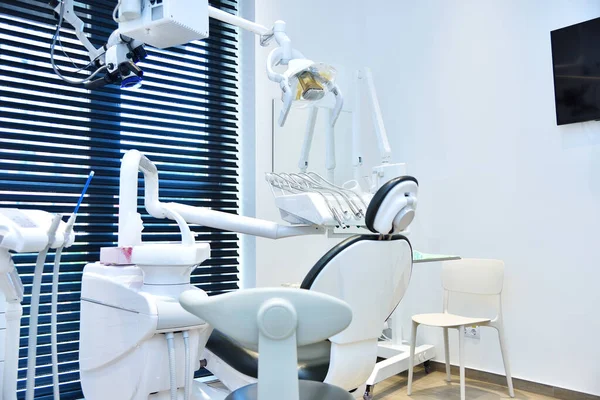 Dental office with dental chair and equipment. Dentistry and health care concept.