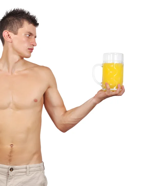 Muskularny mężczyzna trzyma szklankę soku — Zdjęcie stockowe