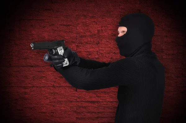 Thug with gun and flashlight — Stock Photo, Image