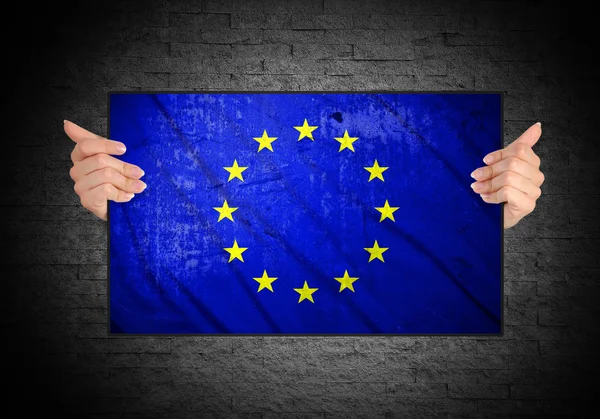Hand holding flag of European Union — Stock Photo, Image
