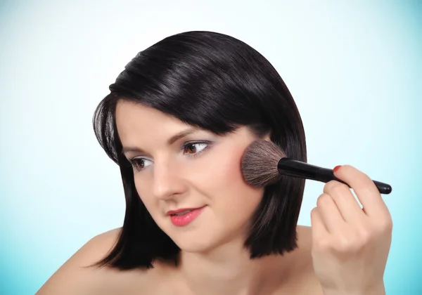 Girl with makeup brush — Stock Photo, Image