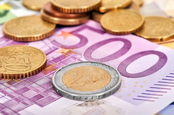 Coins and euro bills — Stock Photo, Image