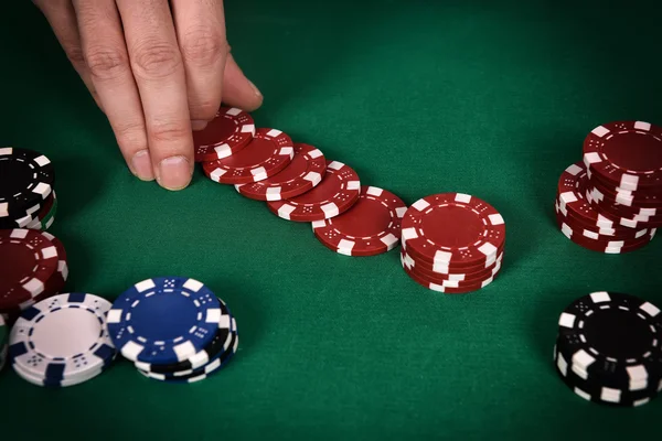 Dealer hands out poker chips — Stock Photo, Image