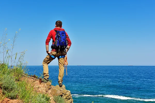 Rock climber looking to sea — Stock Photo, Image