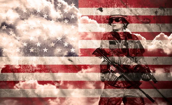 Soldier with rifle on a usa flag background — Stock Photo, Image