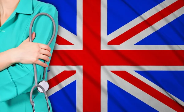 Female doctor and  britain flag — Stock Photo, Image