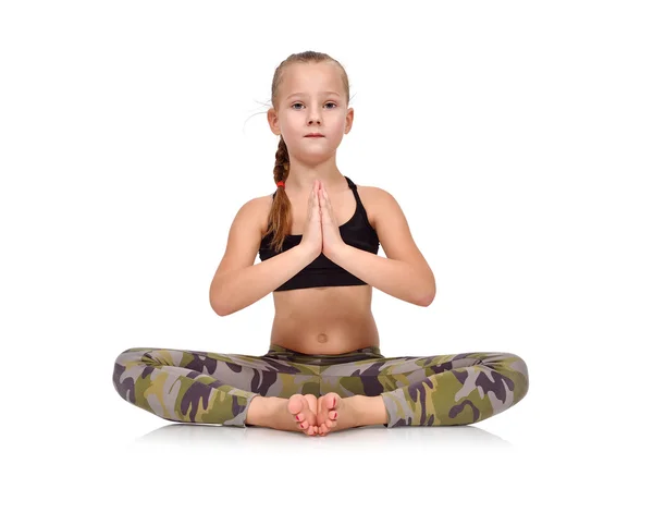 Little girl in camo clothing sitting lotus position on white background — Stock Photo, Image