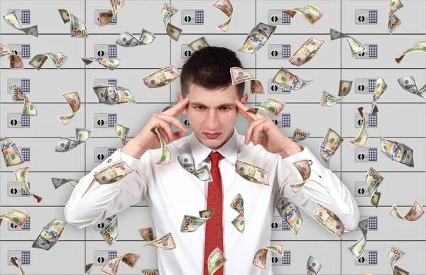 Young businessman thinking and falling dollar bills. — Stock Photo, Image