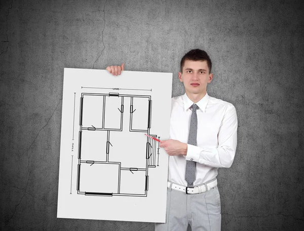 Young businessman holding placard with drawing blueprint — Stock Photo, Image