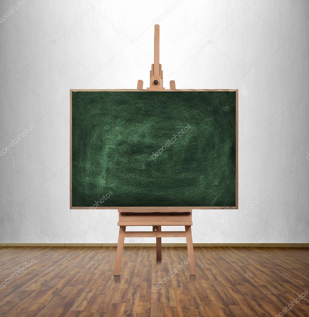 blank green chalkboard in classroom