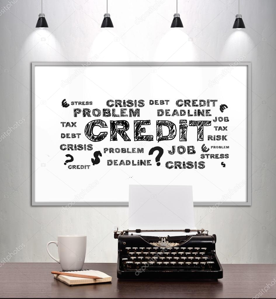 typewriter with paper and placard on wall, credit concept