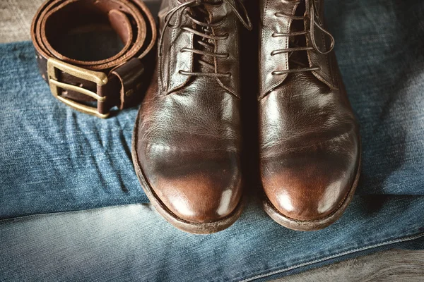 Still life with shoes, jeans and strap, a top view, rustic style — Stock Photo, Image