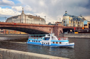 Bolshoy Moskvoretsky bridge, the ship sails along the Moscow river. cityscape in Moscow, Russia clipart