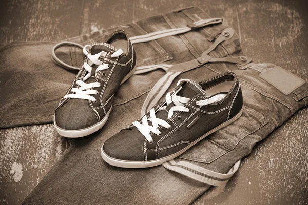 Fashionable sneakers and jeans, photo toning in sepia — Stock Photo, Image