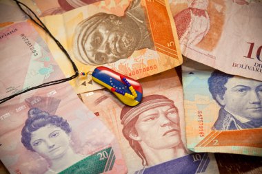 National currency of Venezuela - Bolivar. Suspension - souvenir, painted in the colors of the flag of Venezuela clipart