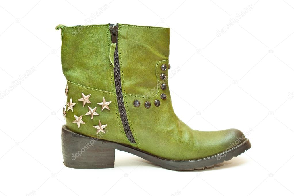 Women's fashion boots green in cowboy style isolated on white background. Photo shoe in profile close-up. Boots with zipper and decorative stars and studs.